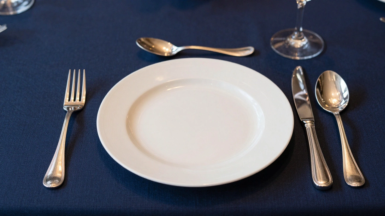 A formal dinner table setting with forks, knives, and spoons arranged around a plate