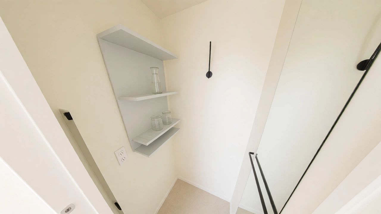 Small bright powder room with light-colored accessories and open shelving